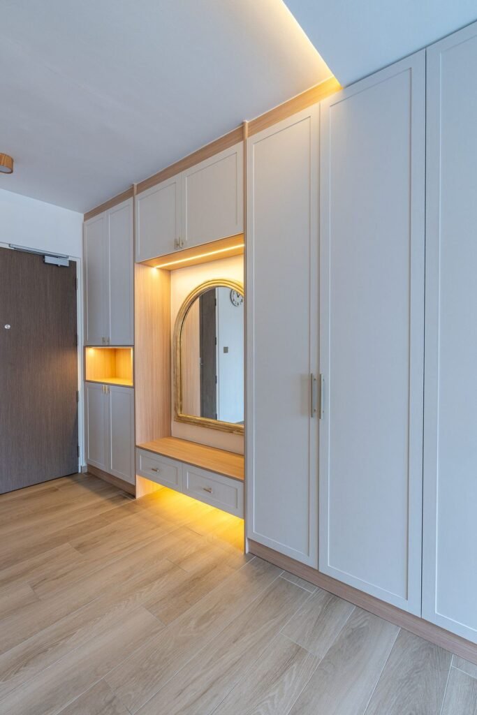 Entrance with a lit shoe cabinet and arched mirror