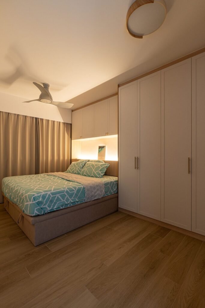 Bedroom with full-height wardrobes and a lit headboard niche