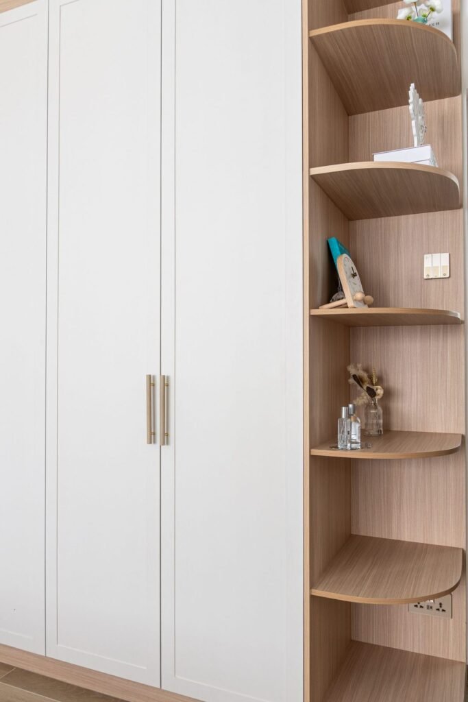 White shaker wardrobe beside curved oak shelves