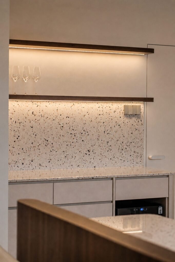 Dining nook with terrazzo backsplash and floating walnut shelves