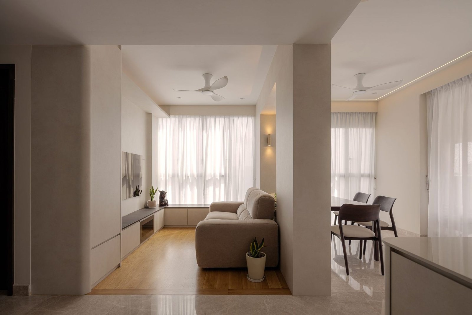 Open living and dining area with oak and marble-look floors