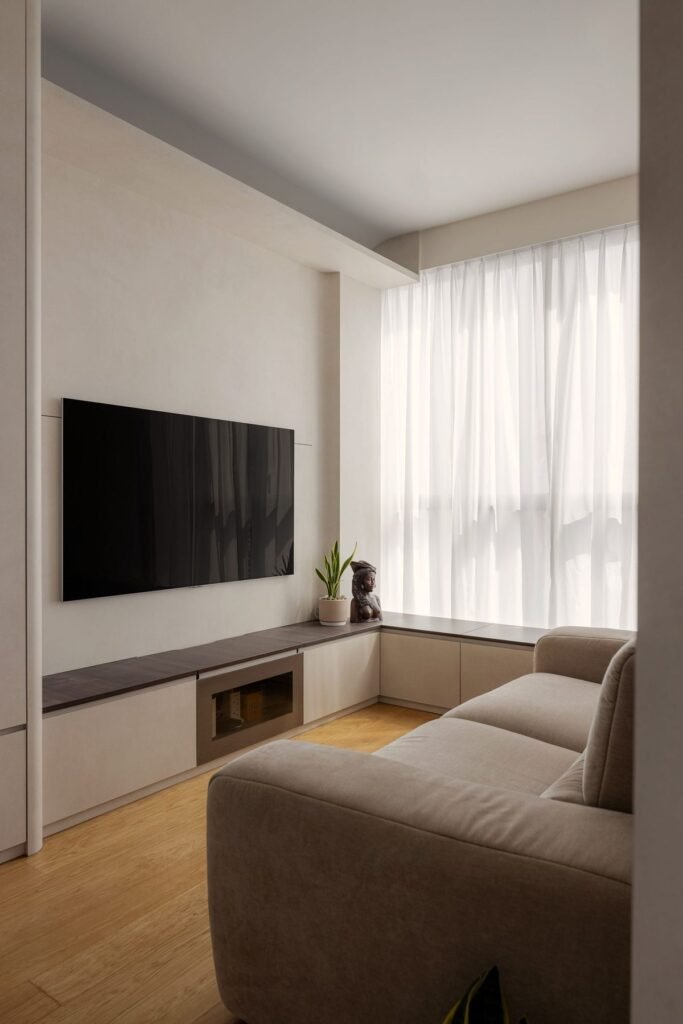 Living room with a low TV console running into a window seat
