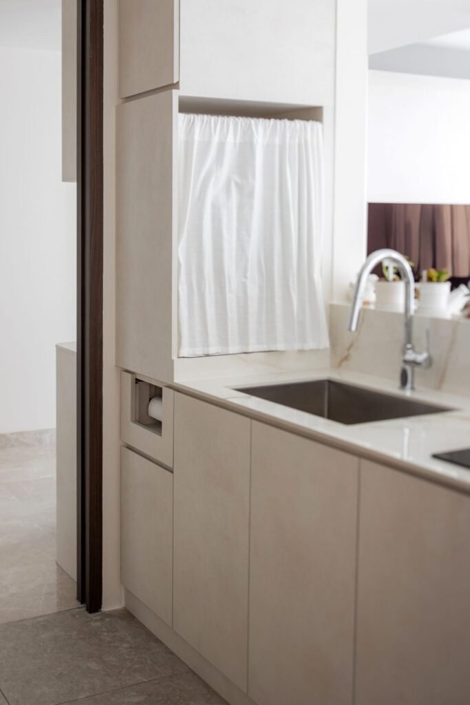 Kitchen sink by the window with tall storage