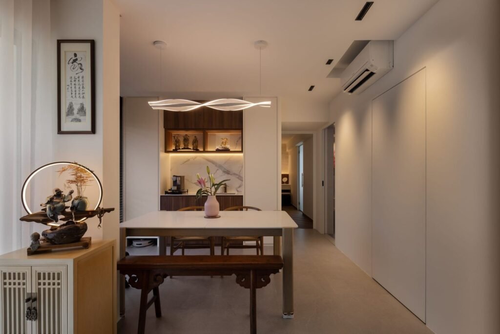 Antique-style furniture and calligraphy against full-height white storage