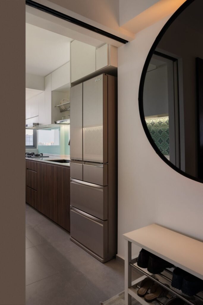 View into the kitchen past the round mirror