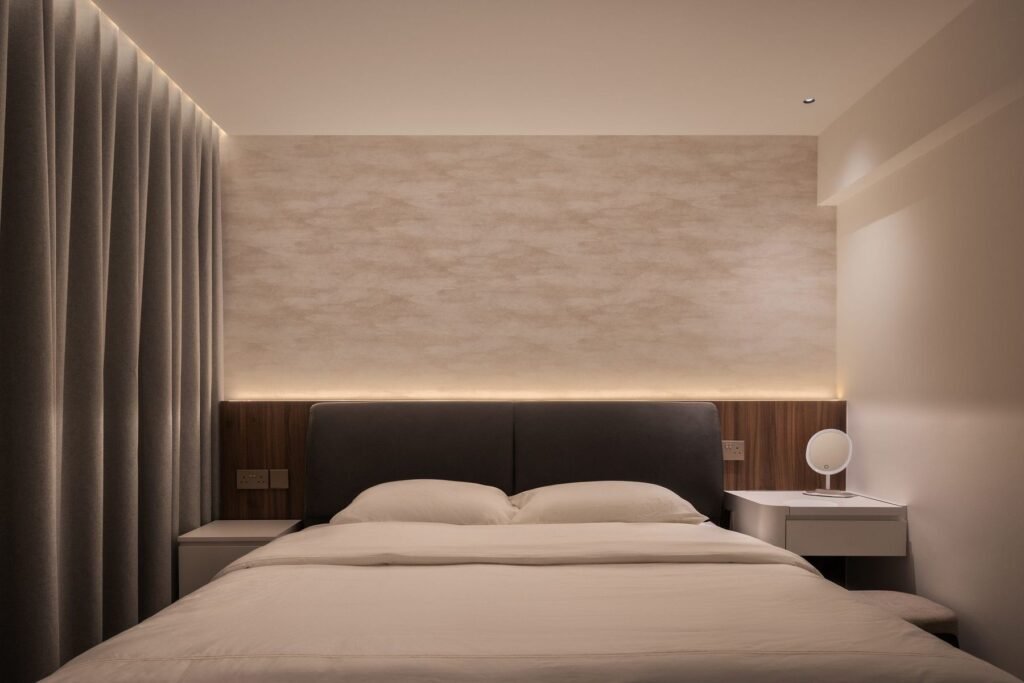 Bedroom with a textured feature wall and lit headboard ledge