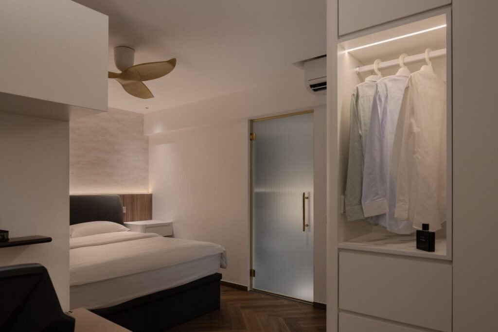 Bedroom with frosted glass door and open wardrobe