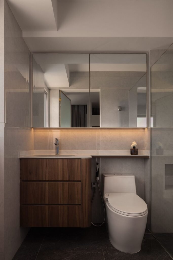 Bathroom with walnut-tone vanity and lit mirror cabinet