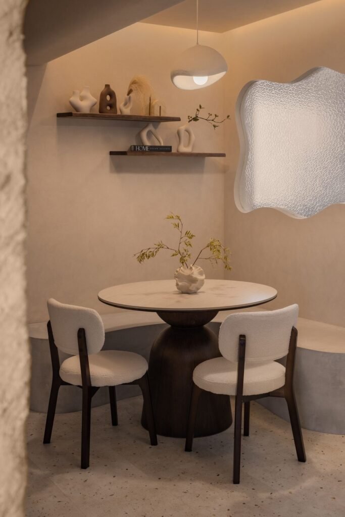 Dining nook with a round pedestal table and paper pendant
