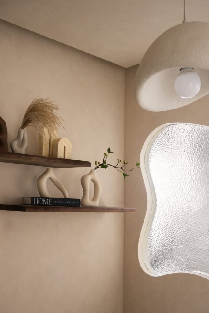 Floating shelves beside an organic textured-glass panel