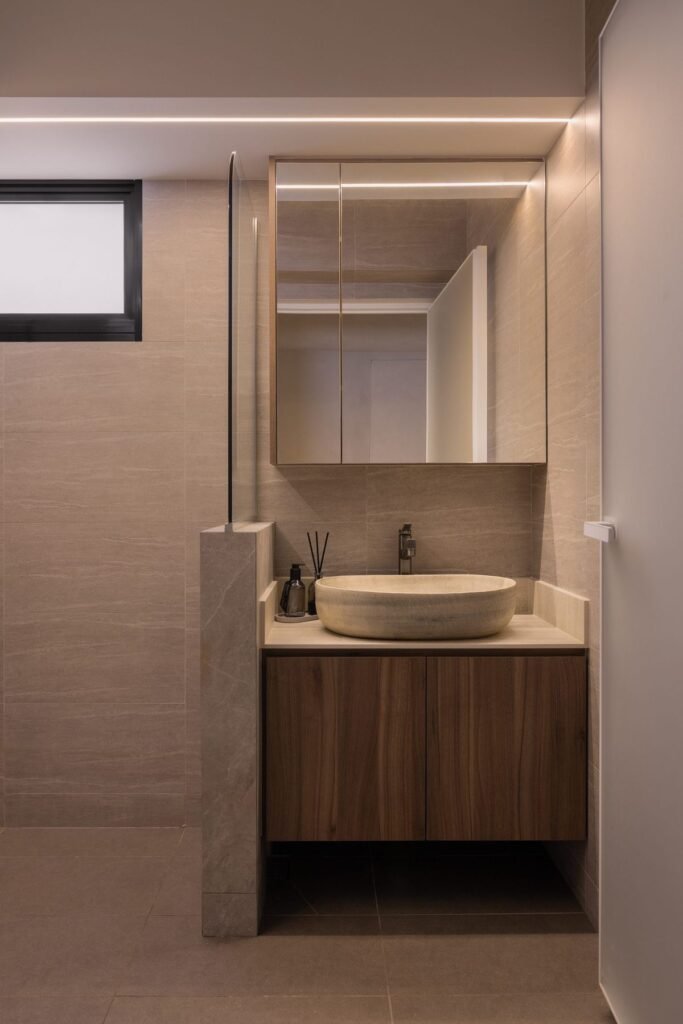 Bathroom vanity with a stone vessel basin and walnut-tone cabinet