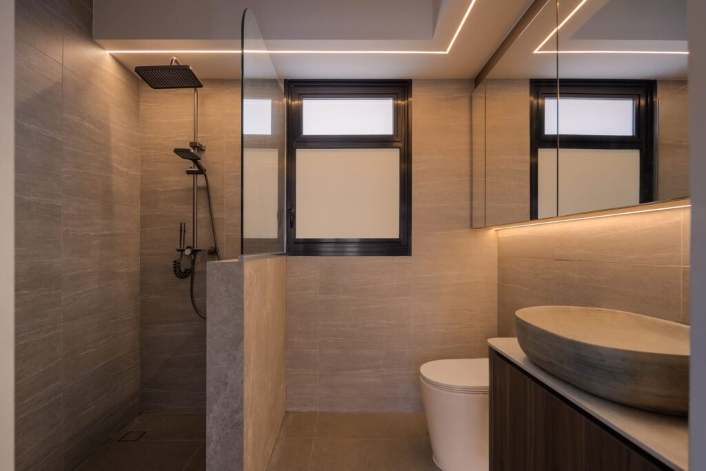 Bathroom in warm stone-look tiles with a walk-in shower
